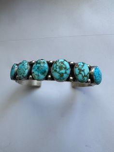 MAIN STONE : Turquoise METAL : Sterling Silver JEWELRY TYPE : Bracelets SIGNED? : Signed TRIBAL AFFILIATION : Navajo This is a wonderful 6 stone Turquoise piece . This cuff is made of Sterling Silver and Turquoise. This piece measures 5/8 inch wide, 6 inch inside circumference and a 1.5 inch gap. The bracelet is signed by the artist S. Tso and stamped sterling. A true beauty!! This listing is for 1 bracelet only. Please contact me with any questions and thank you for looking.Exported By ExportYo Sterling Silver Cuff Bracelet, Sterling Silver Cuff, Silver Cuff Bracelet, Silver Cuff, Turquoise Sterling Silver, True Beauty, Cuff Bracelet, Sterling Silver Jewelry, Silver Jewelry