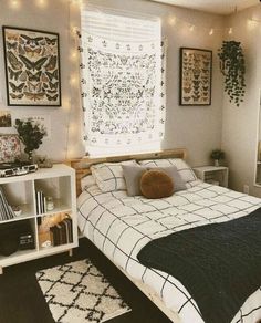 a bed room with a neatly made bed and lots of decorations on the wall above it