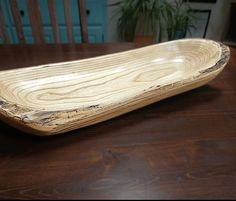 a wooden bowl sitting on top of a table