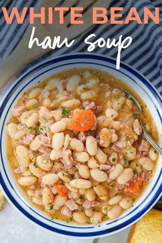 white bean soup with ham and carrots in a blue and white bowl next to bread