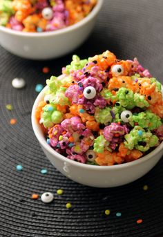 a bowl filled with cereal covered in sprinkles and eyeballs on top of a table