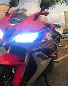 a red and silver motorcycle parked in a parking lot