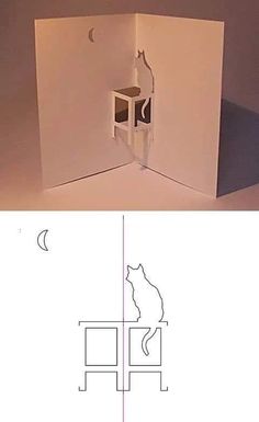 an open white box with a cat sitting on it's back in the corner