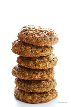 a stack of oatmeal cookies on top of each other in front of a white background