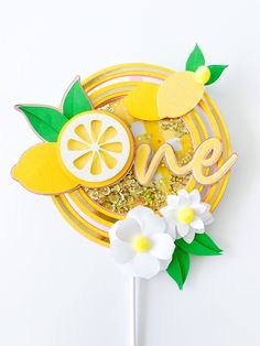 a cake topper with the word love spelled in cut out letters and fruit on it