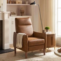 a living room with a chair and fireplace