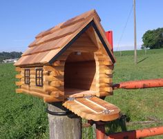 a small wooden house on top of a pole