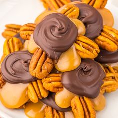 chocolate covered pretzels are piled on top of each other with caramel toppings