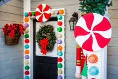 the front door is decorated with candy canes and wreaths