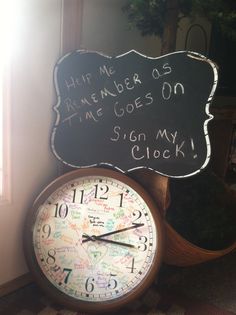 a clock sitting next to a sign that says help me remember us time goes on