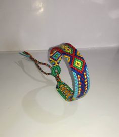 a multicolored beaded bracelet on a white surface