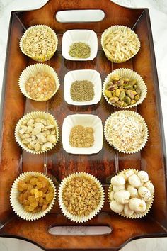 a tray filled with different types of food on top of a wooden table next to other foods