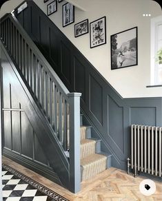 a staircase with pictures on the wall next to it and a radiator below