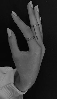 a woman's hand with two rings on it