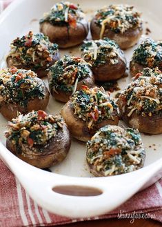 stuffed mushrooms with spinach and cheese in a casserole dish