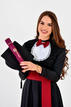 a woman in a black and red dress holding a diploma