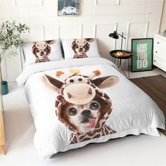 a bed with two pillows on top of it and a pillow case in the shape of a giraffe