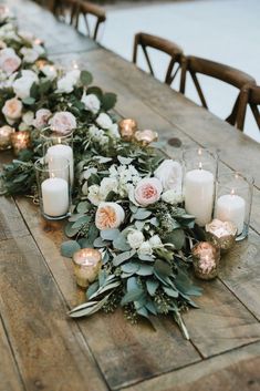 a long table with candles and flowers on it