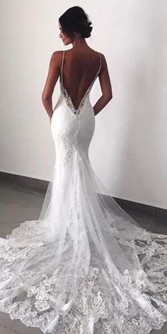 a woman in a white wedding dress looking back