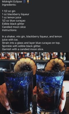 two people holding up glasses with drinks in them and the recipe on the table behind them