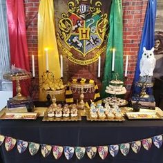 a table topped with lots of cakes and cupcakes on top of a table