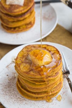 a stack of pancakes with butter being drizzled on top