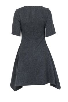 Go cool and classic for the office during those chilly months with this Stella McCartney frock! Made of 100% warm wool with a chic scarf hem in a classic fit and flare silhouette, this simple and sleek beauty is perfect for pairing with all your favorite professional pieces when the weather starts to cool down. Style with polished pumps and your favorite blazer for one bold boss lady ensemble! Size 6 (IT 42) Shell: 100% Wool Lining: 50% Cotton, 50% Rayon Concealed back zipper Lined Fit and flare Sleeve Scarf, Chic Scarf, Stella Mccartney Dresses, English Fashion, Chic Scarves, Sweater Trends, Boss Lady, Luxury Fabrics, Sweater Weather