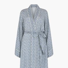 The charming Corina robe is cut from our inimitable cotton and adorned with an interesting blue Ditsy floral print. This oversized kimono-inspired robe boasts fluted sleeves and a detachable belt, creating a flattering silhouette. Contrast piping on the cuff and neck, complete this effortlessly feminine piece.    Cool machine wash only. Wash inside out and with similar colours 100% Cotton Modal   Cool machine wash only. Wash inside out and with similar colours Blue Floral Print Sleepwear For Home, Blue Spring Robe For Loungewear, Floral Print Kimono Sleeves Sleep Robe, Floral Print Long Sleeve Sleep Kimono, Spring Cotton Robe With Floral Print, Blue Floral Print Long Sleeve Kimono, Blue Long Sleeve Kimono With Floral Print, Blue Summer Robe For Daywear, Cotton Floral Print Robe For Daywear