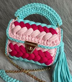 a pink and blue purse sitting on top of a table