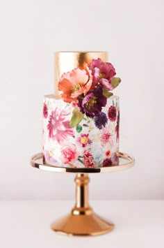 the cake is decorated with pink and purple flowers