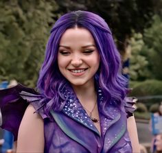 a close up of a person with purple hair wearing a costume and smiling at the camera