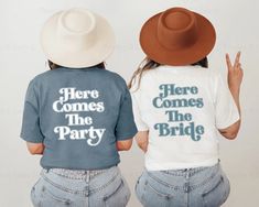 two women wearing t - shirts that say here comes the party