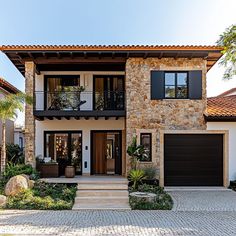 a large house with two garages on each side