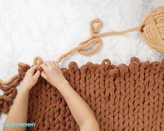 someone is crocheting a blanket with two balls of yarn