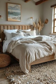 a large bed sitting in a bedroom on top of a wooden floor next to two windows