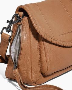 Your favorite soft and slouchy bag is now mini and made to wear on-the-go! With woven leather detailing on the flap - a bit of flare is added to the compact, yet functional mini crossbody bag that will keep you prepared for whatever the day brings. Glove Tanned Leather Signature branded hardware Flap entry with magnetic snap closure Adjustable & removable crossbody strap Back slip pocket 2 exterior zipper pockets at gusset Interior slip pocket Strap Drop: 22" - 25.5" Dimensions: 6" H x 7.75" L x Chic Flap Bags With Leather Handles, Versatile Soft Leather Crossbody Flap Bag, Chic Textured Leather Saddle Bag For Everyday, Chic Everyday Textured Leather Saddle Bag, Everyday Textured Leather Flap Bag, Casual Flap Bag With Detachable Strap, Chic Everyday Saddle Bag With Flap, Versatile Leather Flap Bag, Versatile Flap Bag For Everyday Use