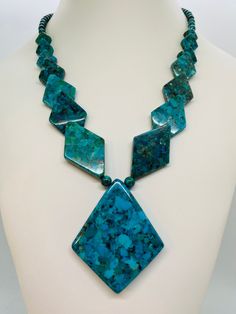 "Signed Sterling Silver Turquoise Necklace. Pretty Art Deco design. Colors are slightly darker in the photos than actual. *  Measures 18\"-20\" long. Center stone measures nearly 2.5\" long. *  Signed DTR / Sterling (Designer Jay King) *  Condition: pre-owned / Great condition! *  Check out our other Jay King items! Visit our shop for even more Vintage Estate Jewelry & unique finds.  Shipping: Items will be shipped within 3 business days after we receive payment. We take care in our packaging to Luxury Traditional Kingman Turquoise Necklace, Turquoise Necklace With Large Chrysocolla Pendant, Jay King Jewelry, Blue Turquoise Necklace With Large Chrysocolla Pendant, Turquoise Chrysocolla Necklace With Large Pendant, Luxury Silver Kingman Turquoise Necklace, Blue Chrysocolla Necklace With Large Stone, Blue Turquoise Chrysocolla Necklace With Large Pendant, Unique Turquoise Nickel-free Necklace