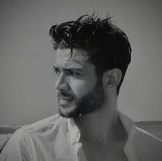 a black and white photo of a man with wet hair on his head looking off to the side