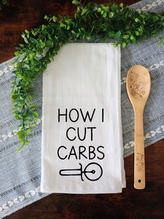 a tea towel with the words how i cut cars printed on it next to a wooden spoon