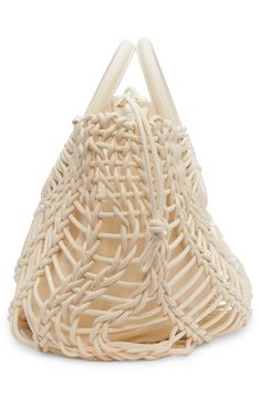 the woven bag is white and has two handles