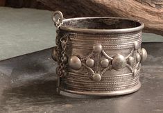 This is a gorgeous silver Rashaida cuff, likely made in the Mid 20th Century. The Rashaida are a Bedouin Arab tribe native to the Hejaz region of the Arabian Peninsula (in Western Saudi Arabia) who migrated in the mid 1800s to southern Egypt, Sudan and the Horn of Africa. These cuffs would typically be given to brides in pairs and worn daily. This one shows some wear and tear through the ages (most notably one of the half sphere accents is flattened on top as seen in last photo), but is overall Horn Of Africa, Arabian Peninsula, The Horn, Saudi Arabia, Merlin, 20th Century, Cuff Bracelets, Jewelry Bracelets, Cuff