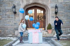 a man and woman are standing in front of a house with balloons flying around them