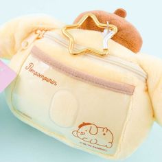 Use this super cute Pompompurin head case to store your pass card! It comes with a zippered compartment and a star-shaped hook that has a pull-out reel. This fluffy plushie can also be used as a bag charm. A cute pass case and plushie charm shaped like Pompompurin’s head Comes with a designated card slot, a zippered compartment, and star-shaped metal hook with a pull-out reel Original licensed product from Sanrio Japan Cute Pompompurin, Pum Pum, Kawaii Accessories, Hello Kitty Items, Kawaii Aesthetic, Kawaii Shop, Eco Bag, Purim, Sanrio Characters