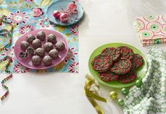 a table topped with plates filled with cookies