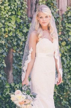 a woman in a wedding dress holding a bouquet