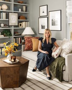 a woman sitting on top of a couch in a living room