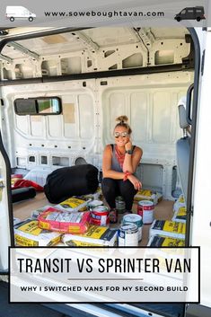 a woman sitting in the back of a van with paint cans on the floor next to her