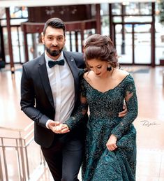 a man and woman dressed in formal wear