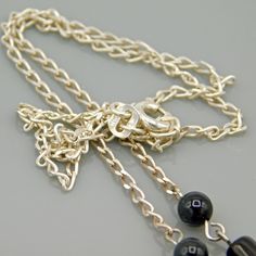 "Simple and unique sterling chain necklace is made with a medium fine diamond cut chain with black glass beads accenting it. A chain \"pendant\" is 1 /78 inches long. This cute necklace is simple and versatile in black silver colors. Closes with a spring ring clasp and is in excellent condition. Find lots more vintage jewelry at Purple Daisy Jewelry! http://www.etsy.com/shop/purpledaisyjewelry Thanks a bunch for shopping for vintage jewelry at Purple Daisy Jewelry on Etsy!" Black Rolo Chain Necklace As A Gift, Black Rolo Chain Necklace For Gift, Black Pendant Necklaces With Beaded Chain, Black Pendant Necklace With Silver Chain, Sterling Silver Black Chain Necklace For Gift, Black Sterling Silver Chain Necklace Gift, Black Sterling Silver Chain Necklace, Black Sterling Silver Pendant Necklace, Sterling Silver Black Beaded Chain Necklaces