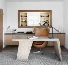 an office with a desk, chair and bookshelf